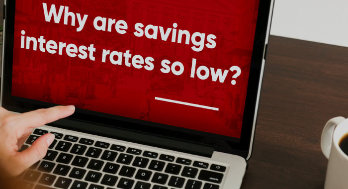 Computer screen with the question "Why are savings interest rates so low?" from the Town Hall presentation showing on the screen. 