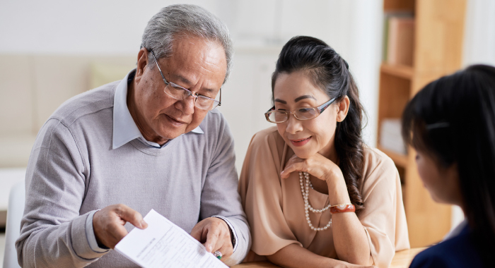 elderly couple looking at estate paperwork