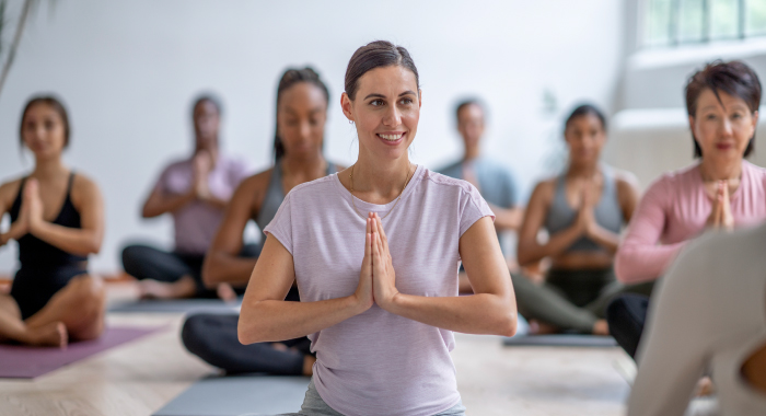 person smiling in a yoga class