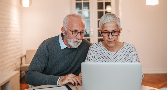Elderly couple looking at a laptop
