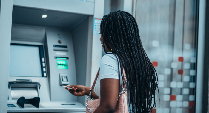 Person making a transaction at an ATM